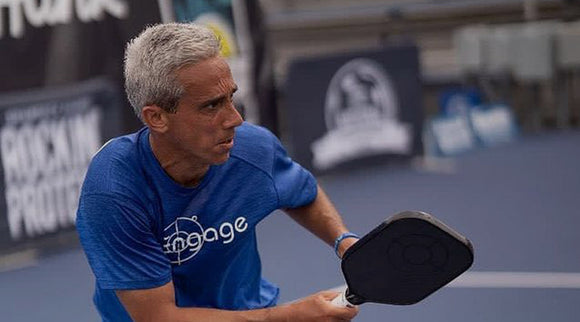 Jose Derisi, a top Senior Pro Pickleball player, intensely focused as he competes in a high-stakes pickleball match, demonstrating his skill and athleticism.