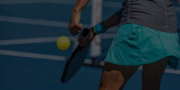 An Engage Pro Player serving on court while using her Engage Pickleball paddle